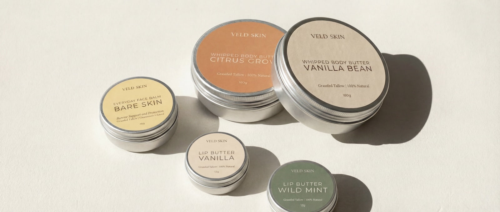 Collection of Veld Skin body butter tins on a light background