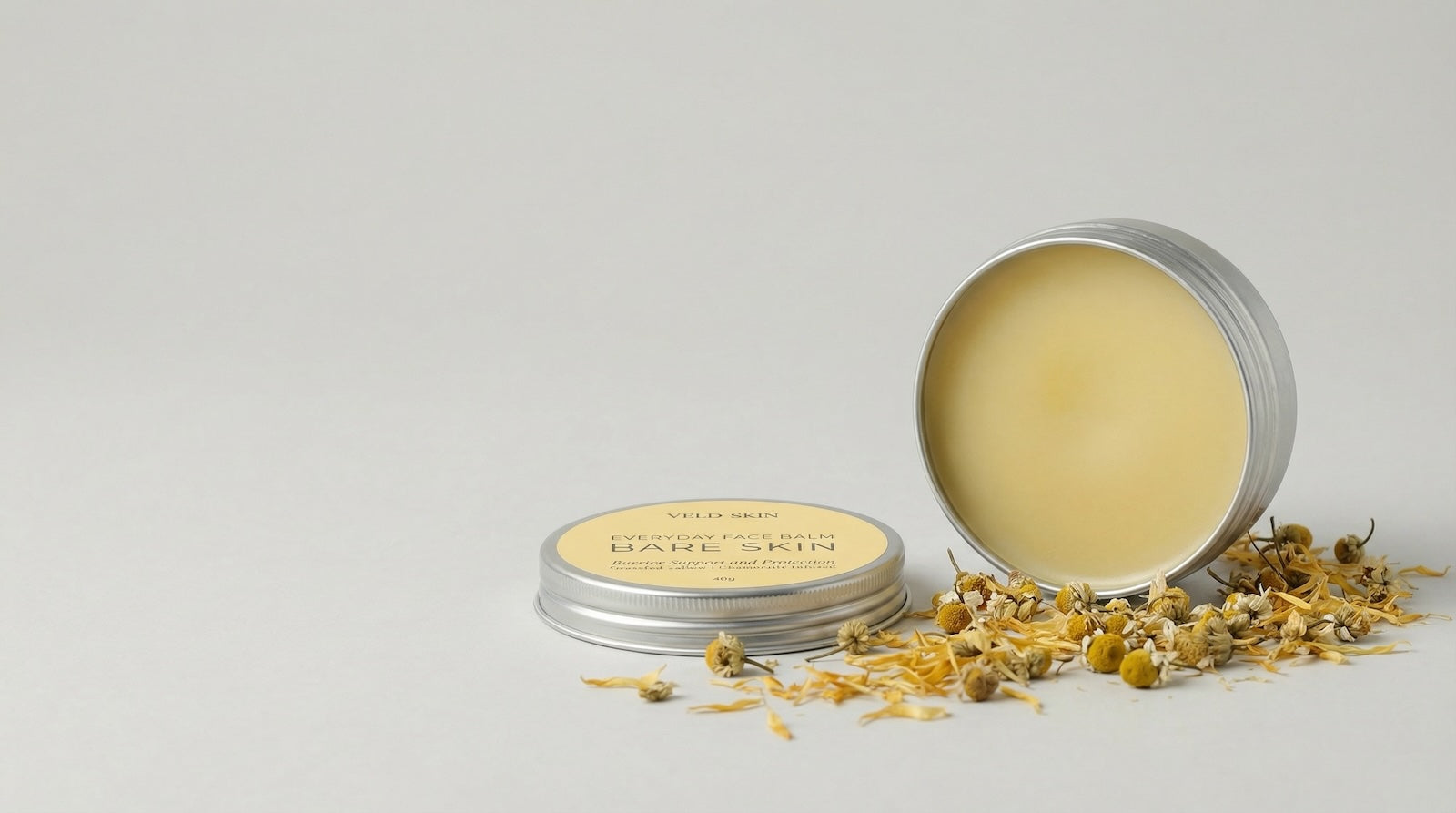 Balm in a metal tin with 'Bare Skin' branding on a light gray background