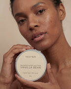 Woman holding a container of Veld Skin Whipped Body Butter Vanilla Bean