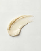Swatch of beige cream on a light gray background