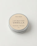 Lip butter container labeled 'Vanilla' by Veld Skin on a light background
