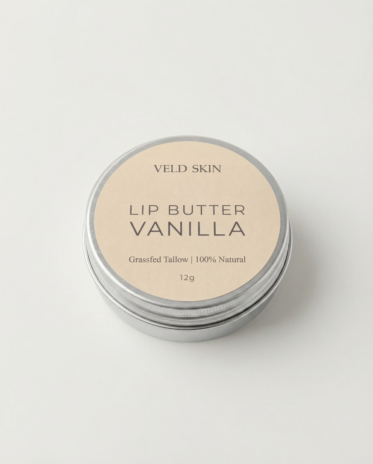 Lip butter container labeled 'Vanilla' by Veld Skin on a light background